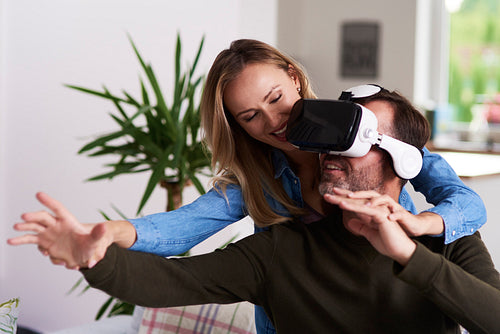 Modern couple using virtual reality simulator