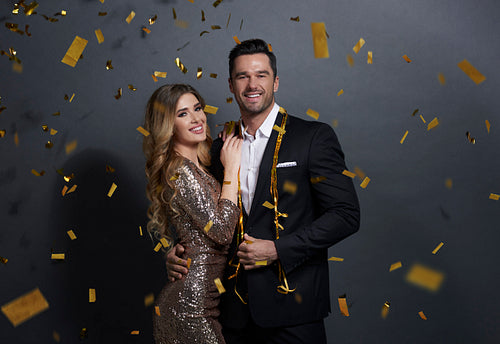 Portrait of embraced couple celebrating New Year at studio shot