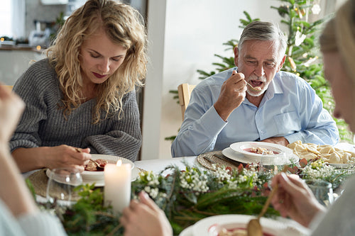Caucasian family eating traditional Polish soup at Christmas Eve