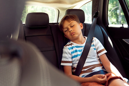 Boy sleeping while riding in car