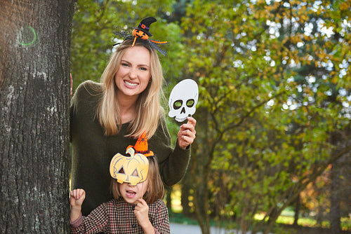 Mother and her daughter in halloween masks