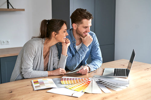 Caucasian couple choosing colors for new house