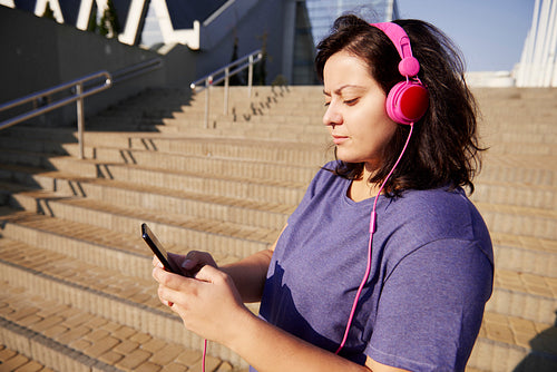 Woman choosing perfect playlist for morning running