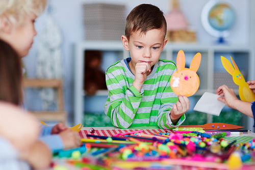 Focused boy with handmade decoration for Easter