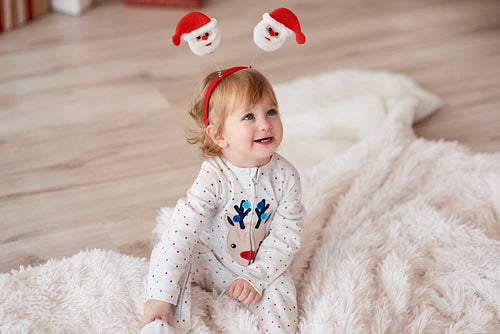 Charming baby in Christmas morning