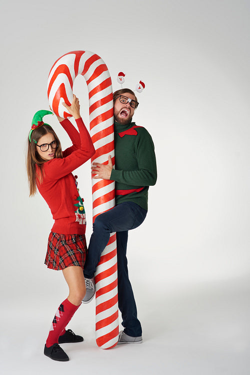 Funny Christmas couple with candy cane