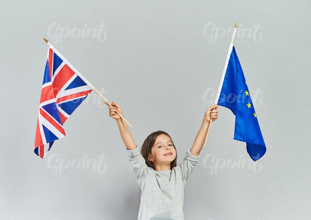 Child waving British flag and European Union flag