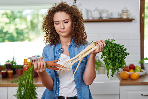 Young woman thinking of what to cook