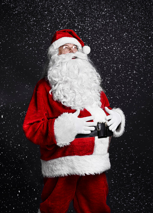Cheerful santa claus touching his belly