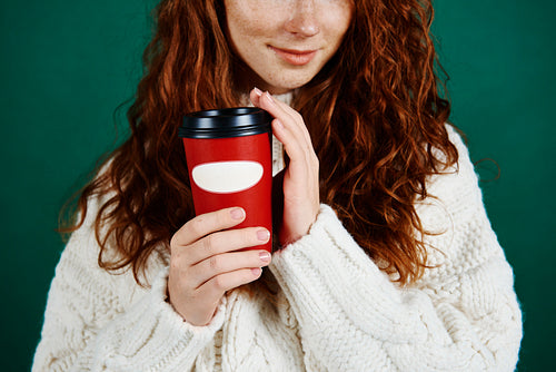 Close up of girl holding disposable mug of coffee