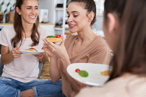 Three women during a homemade food feast