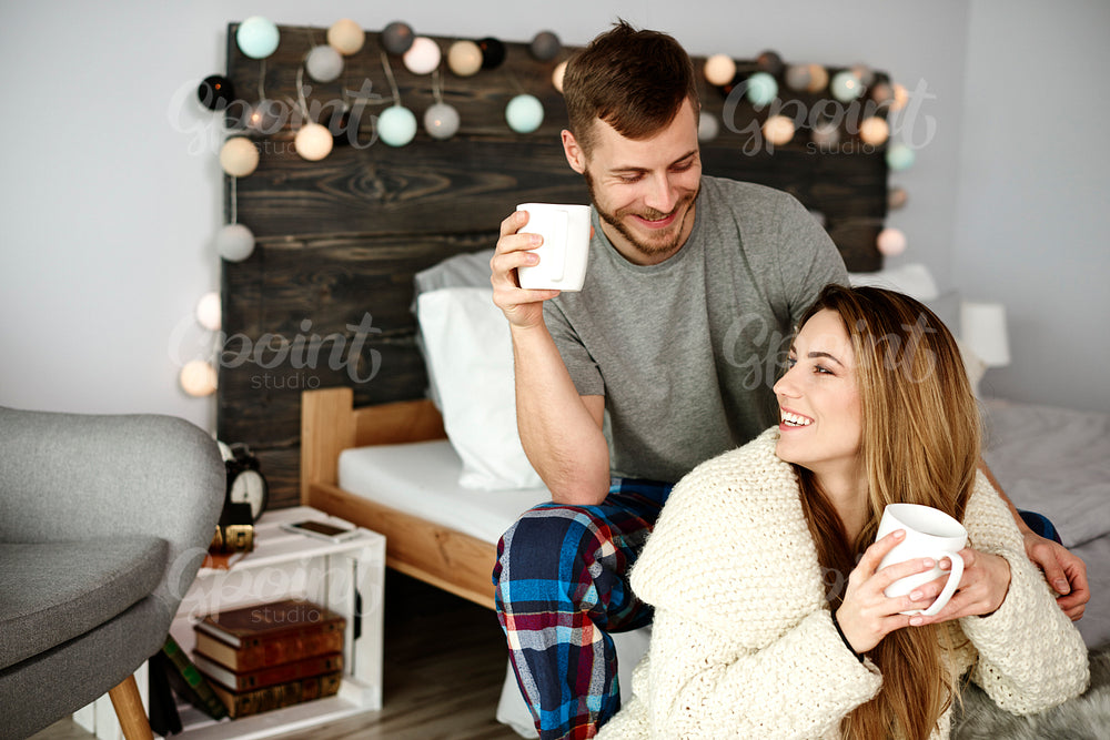 Affectionate couple flirting and drinking coffee