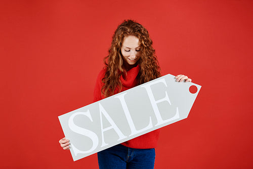 Young girl showing banner of winter sale