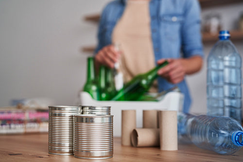 Woman recycling garbage at domestic kitchen