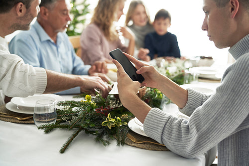 Caucasian man spending Christmas Eve with mobile phone