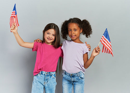 Two girls holding American flag