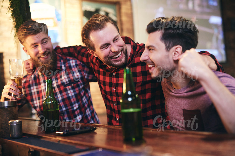 Three men enjoying time together in the pub