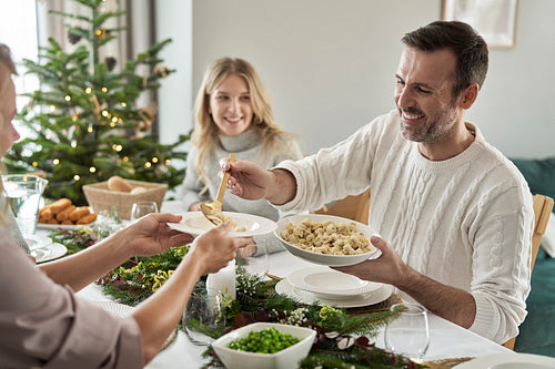 Caucasian man sharing ravioli at the Christmas Eve