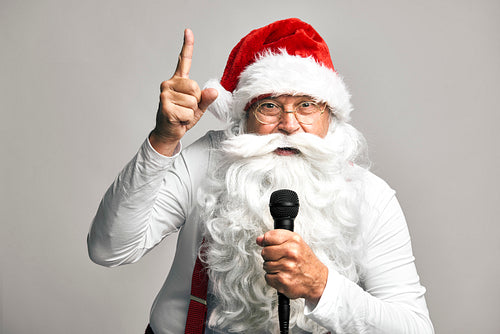 Caucasian Santa Claus singing to microphone