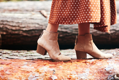 Boots of woman in autumnal forest