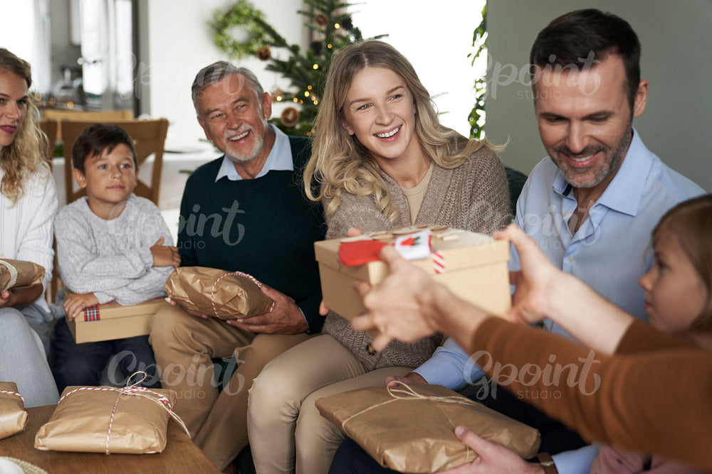 Multi generation caucasian family sharing Christmas presents and having fun