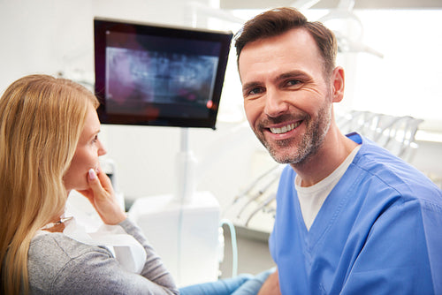 Portrait of smiling and confident dentist in dentist's clinic