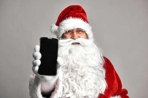Santa Claus showing screen of mobile phone
