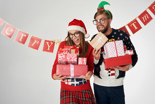 Couple holding Christmas presents in hands