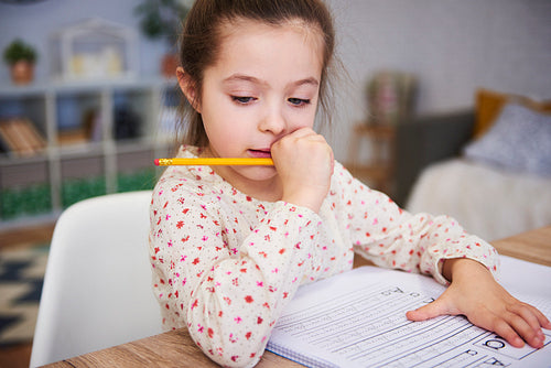Focused girl doing her homework at home