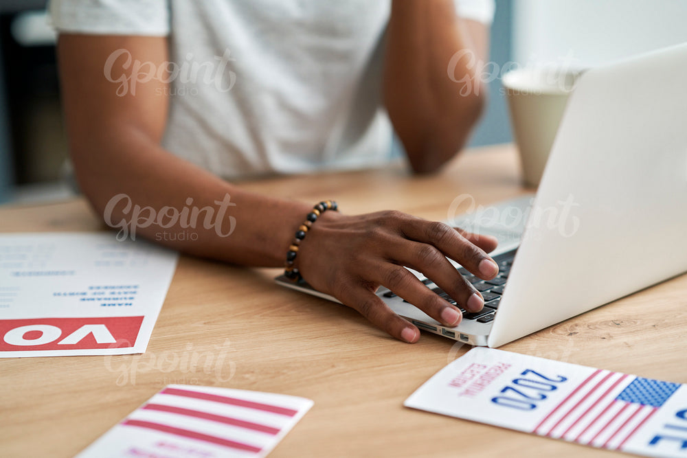 Unrecognizable man looking for information about election in the Internet