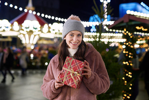 Portrait of woman with presents on Christmas Market