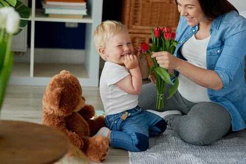 Mother receiving beautiful flowers from her toddler boy