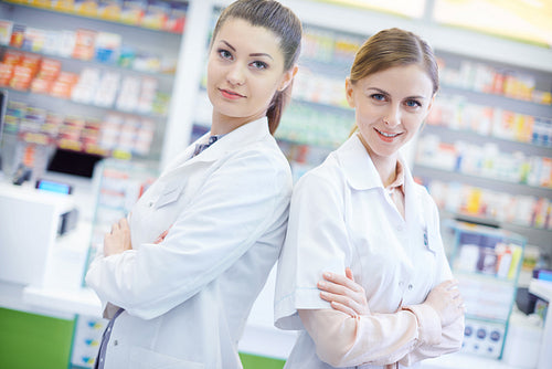 Two attractive pharmacists in pharmacy