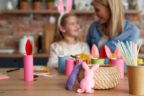 Handmade Easter rabbits and mom and daughter in the background