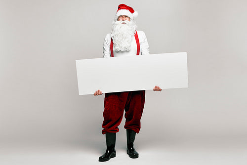 Caucasian Santa Claus with empty poster