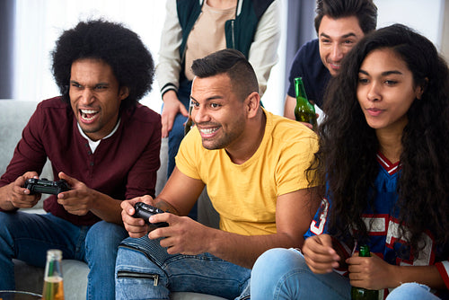 Friends having fun while playing a game console