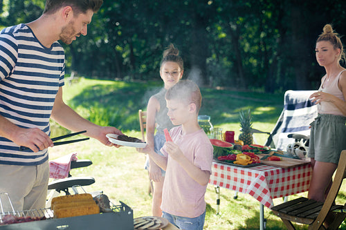Family ready to eat a barbecue meals