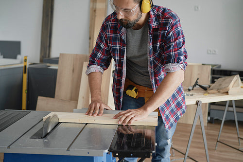 Carpenter during work using a circular saw