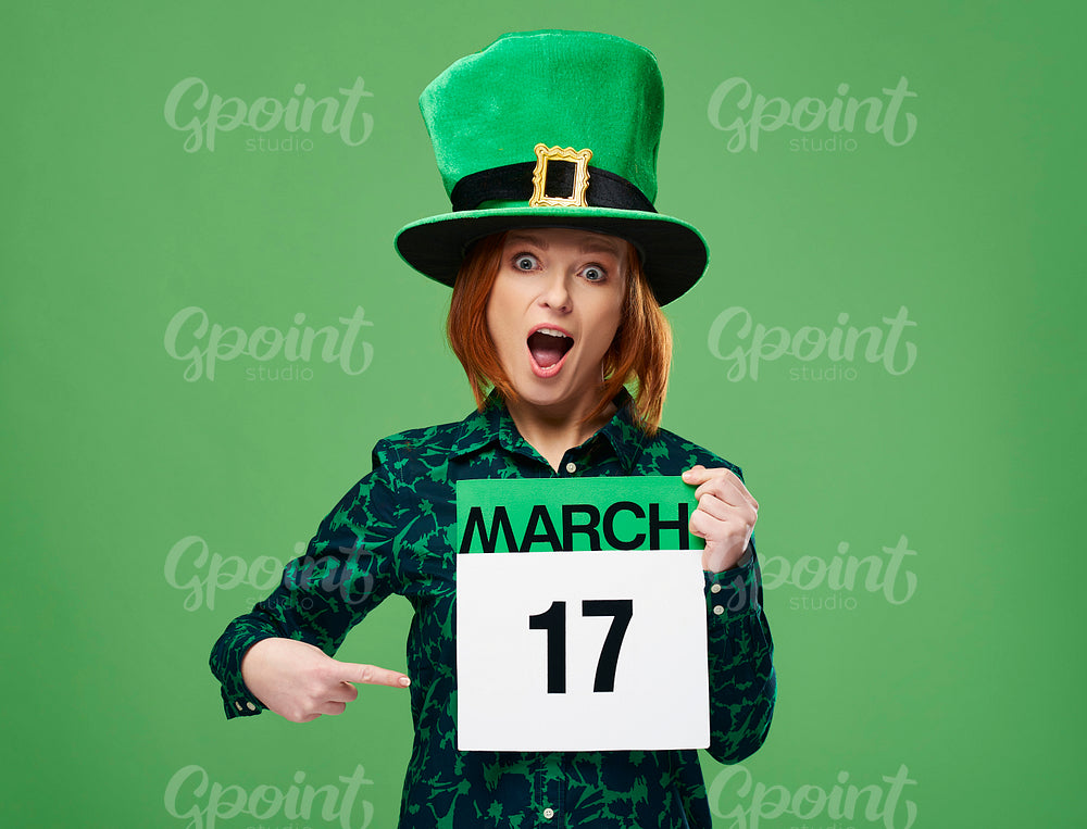 Screaming woman with leprechaun's hat pointing at calendar