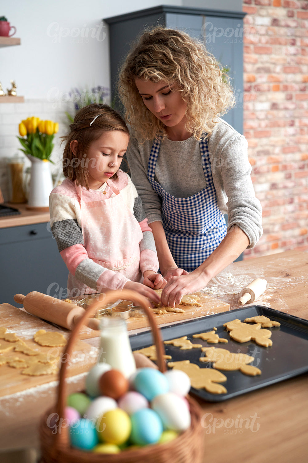 Daughter and mother  making Easter cookies at home