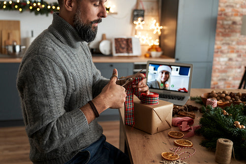 Man during video call making Christmas present