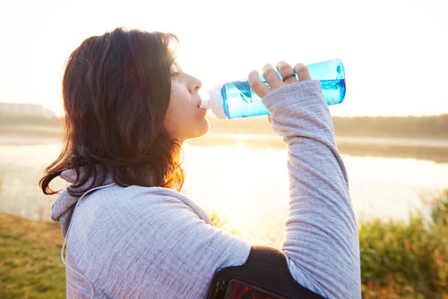 Woman drinking water after really hard workout