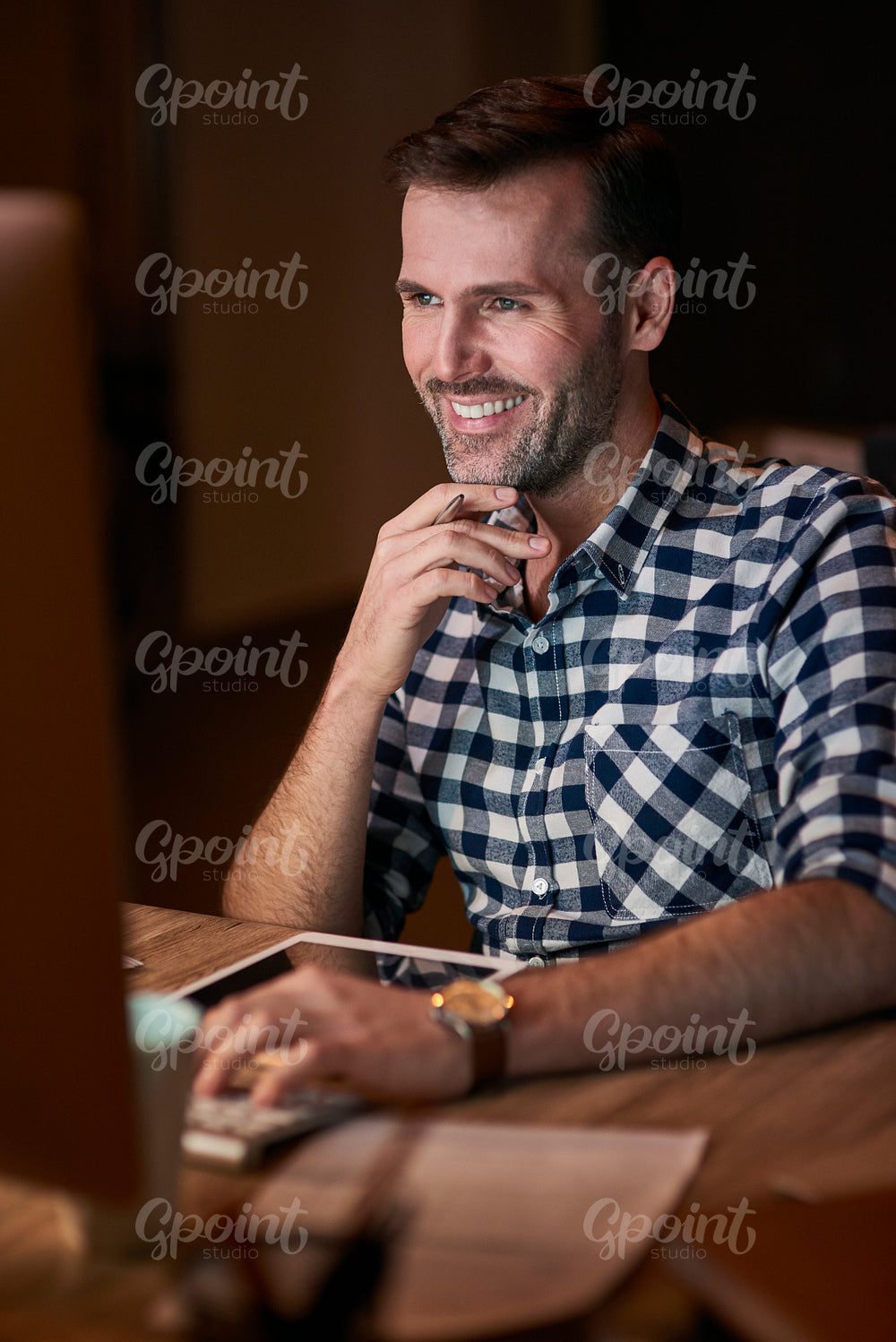 Man typing on computer keyboard in home office