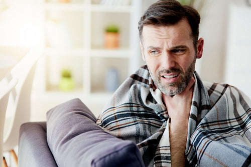 Man with a sore throat staying at home