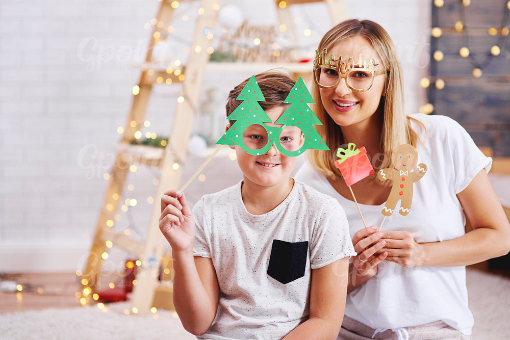 Portrait of mother and son with christmas mask
