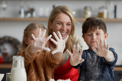 Happy children after baking with mother