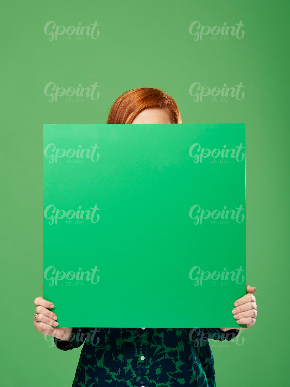 Young woman holding banner with copy space in studio shot