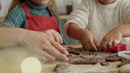 Video of mother helping children with cookie baking