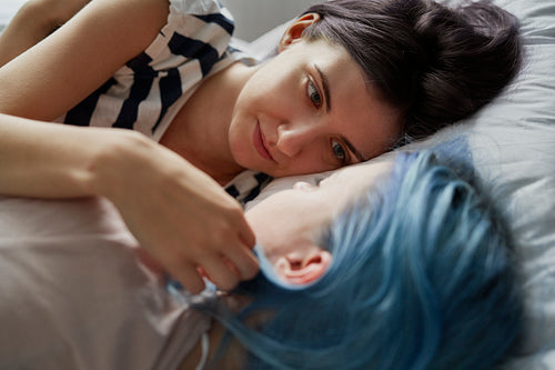 Close up of infatuated lesbian couple lying on bed