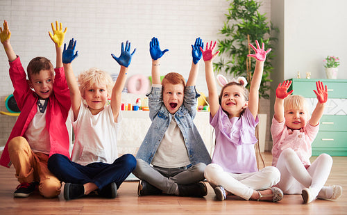 Group of children with colorful, painted hands